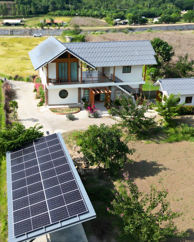 Ground-mounted solar array in the garden of a Thai house