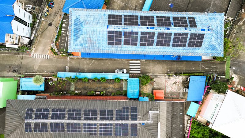 Aerial view of two school buildings with rooftop solar arrays