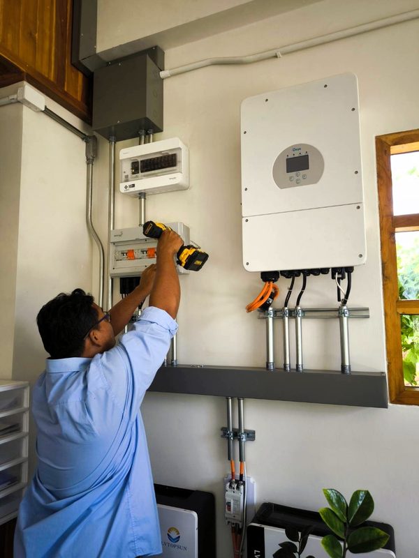 Technician working on the wall-mounted inverter
