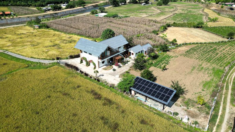 Aerial view of the farmhouse, array and surrounding farmland