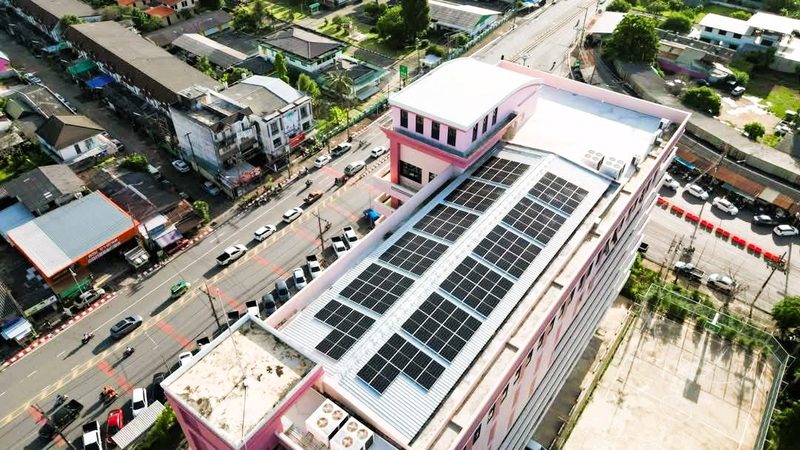 Aerial view of rooftop panels with the town behind